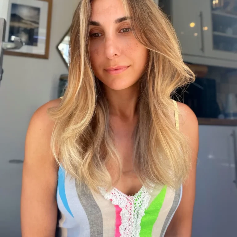 Client posing very happy after a balayage hair service in Carlisle, Cumbria.